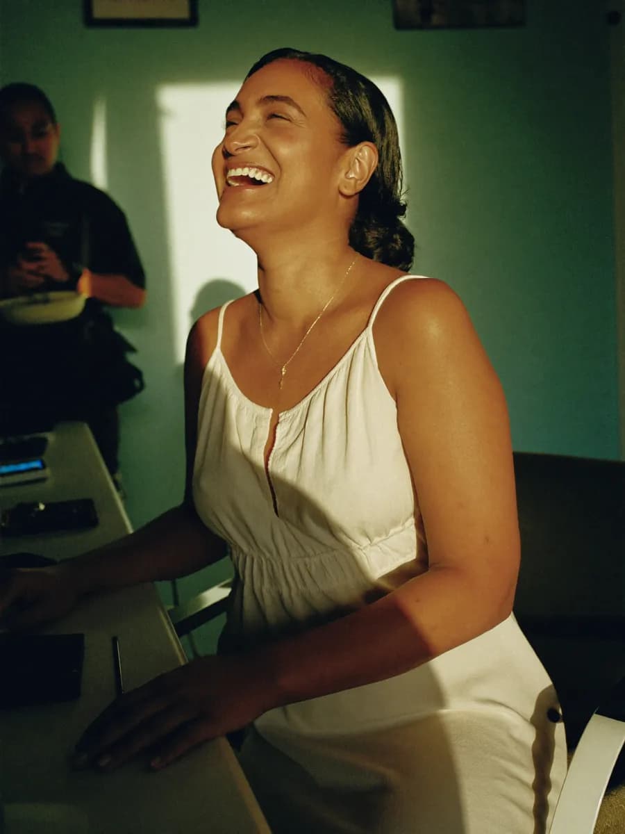A guest laughing at the counter after her appointment